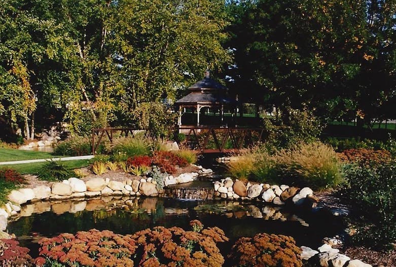 Completed landscape with gazebo, pond, and mature plantings